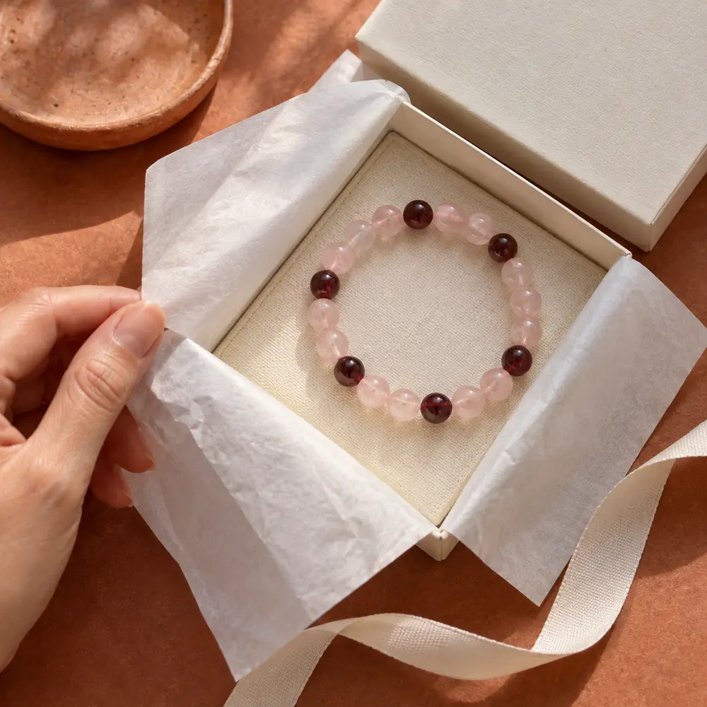 Rose quartz and garnet bead bracelet in an open gift box